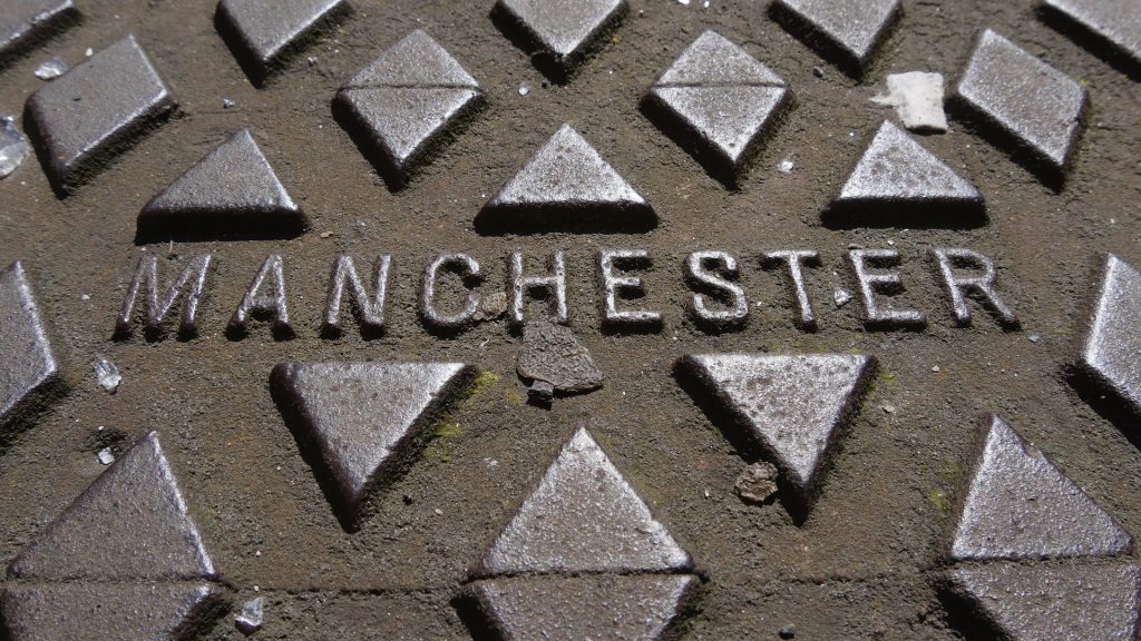 Manhole cover with Manchester printed on it
