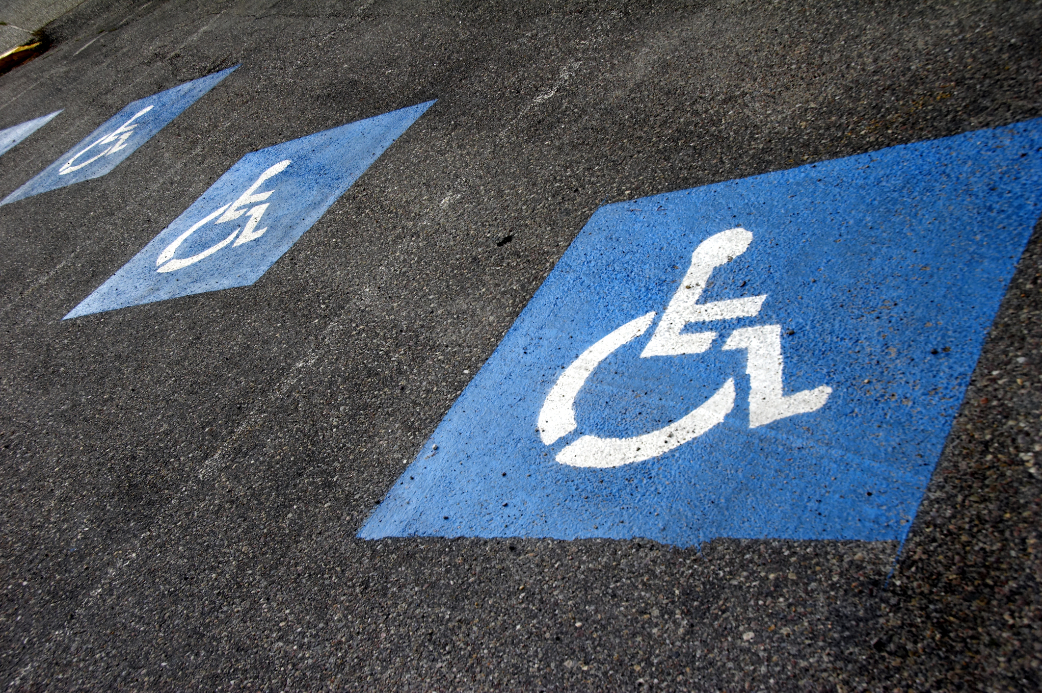 wheelchair user icon white against blue background