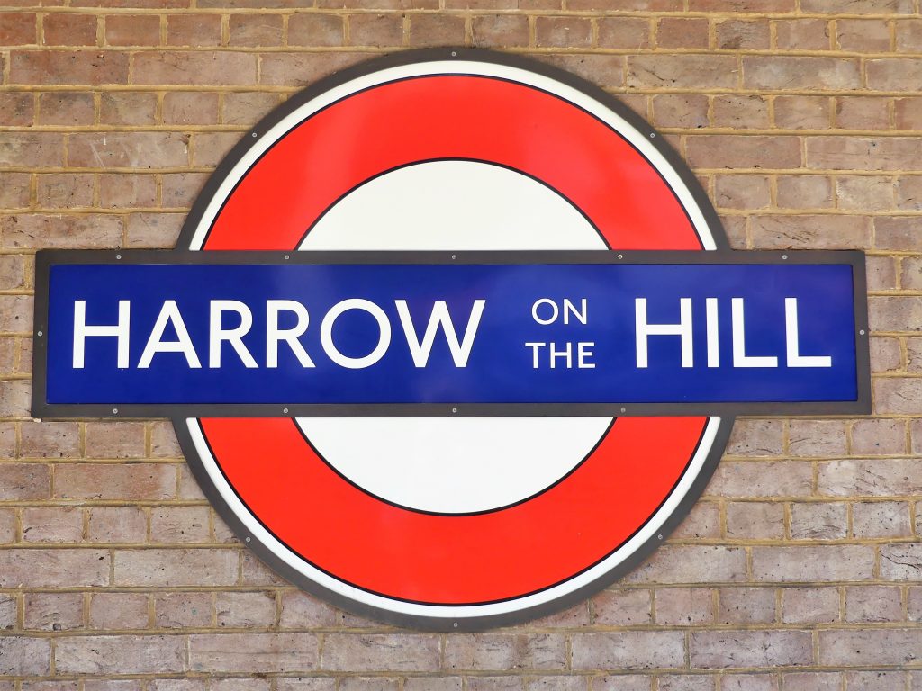 Harrow on the Hill underground sign against brick wall