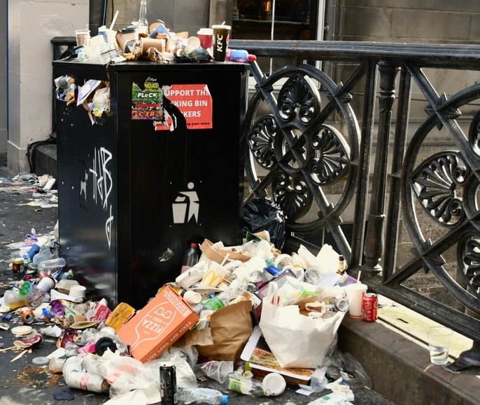 overflowing waste bin on London street